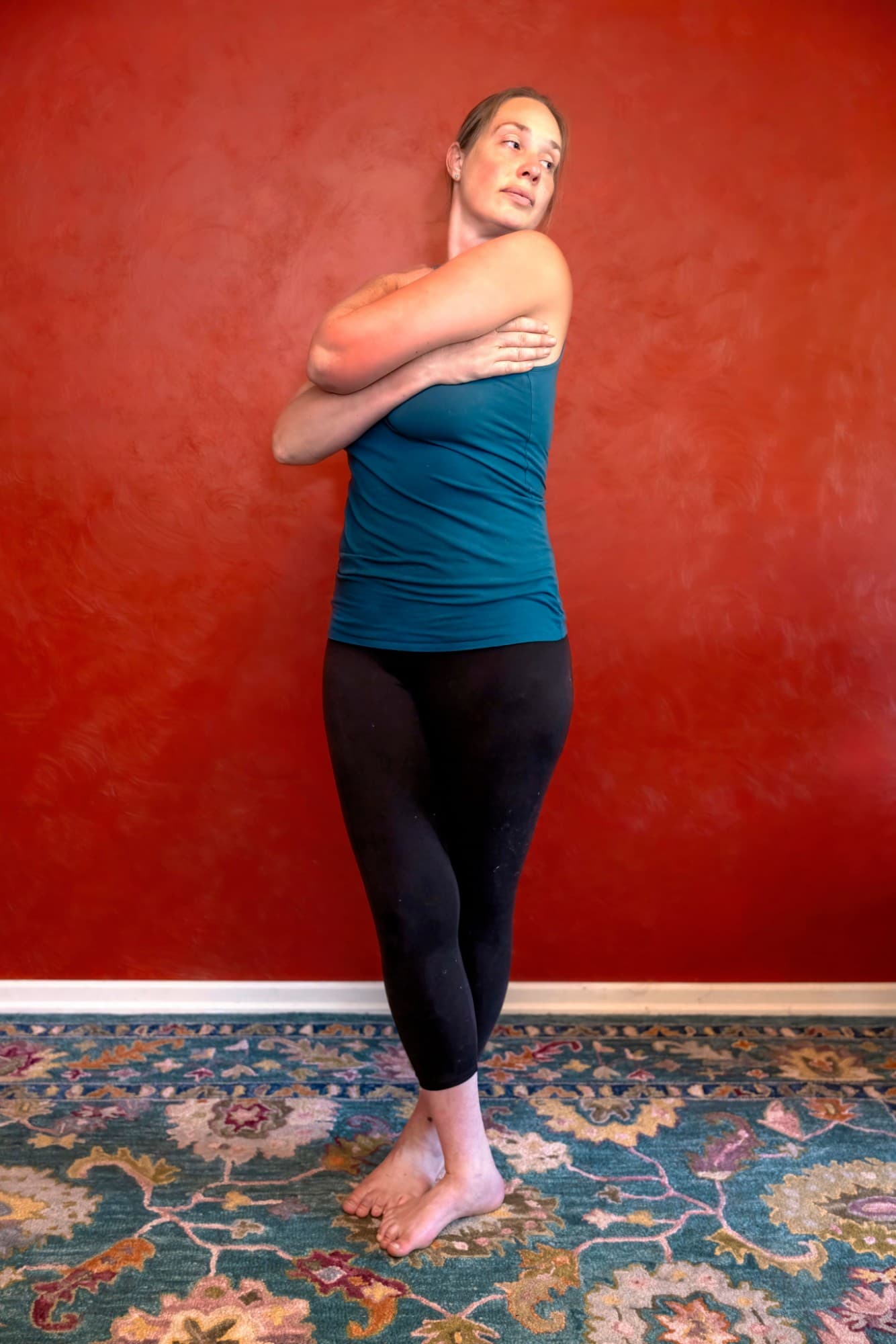Maria demonstrating a standing shoulder and neck release with a rotational hold